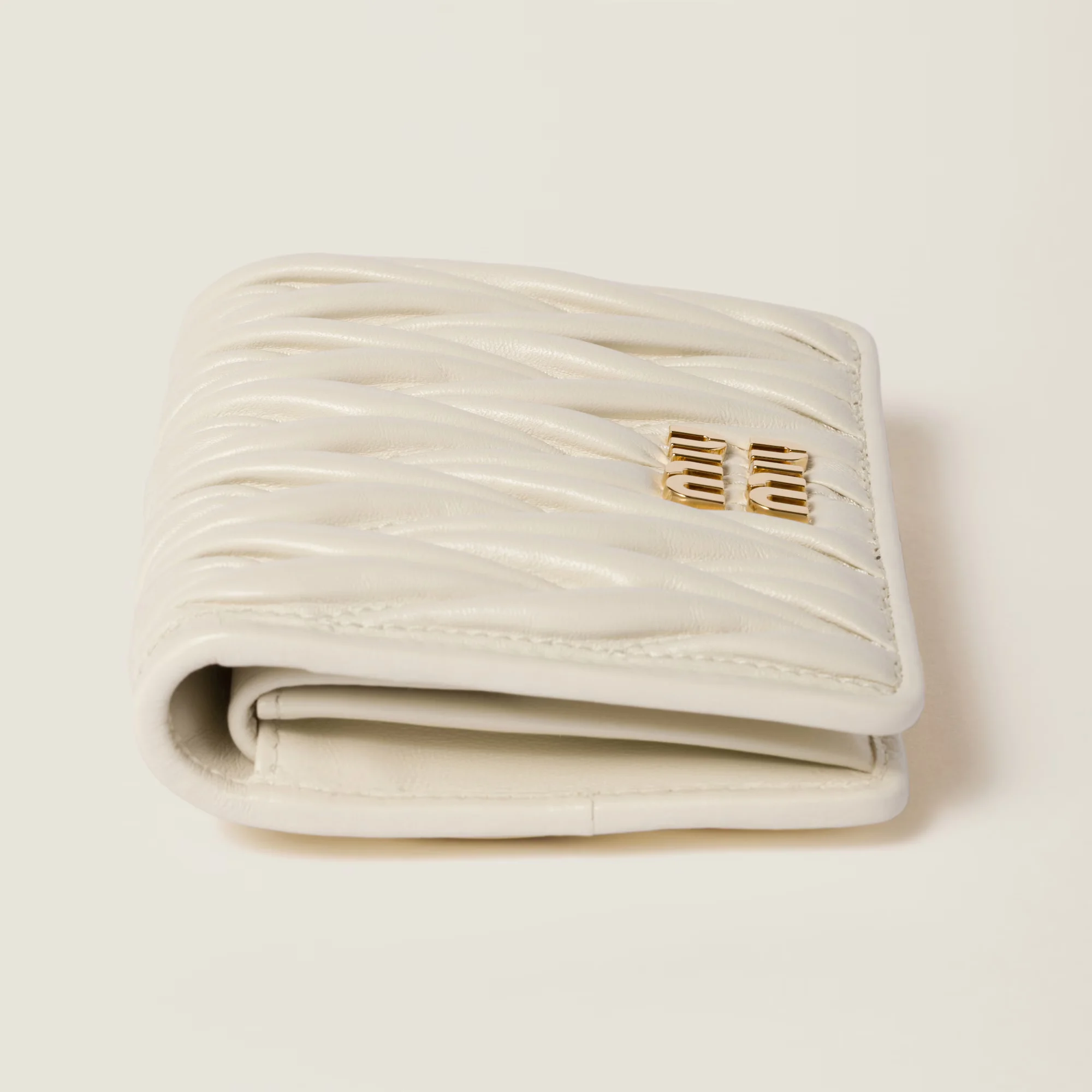 Close-up view of a trending Miu Miu matelasse wallet in soft pastel tones for fashionistas