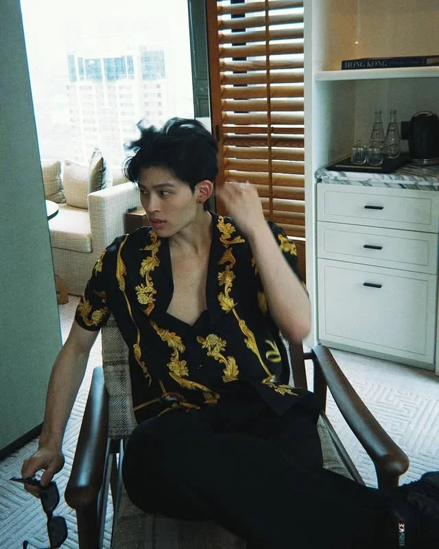 Pond Naravit wearing iconic Versace Barocco gold silk shirt