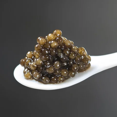 Close-up of premium black sturgeon caviar on a pearl spoon